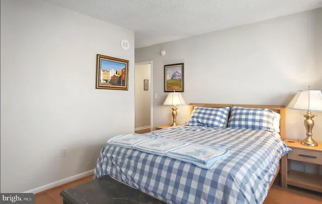 a bedroom with a bed and a painting on the wall