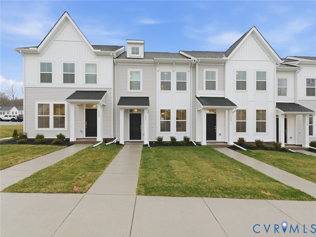 front view of a brick house with a yard