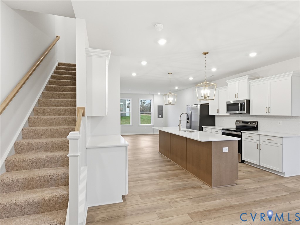 157 Corcoran Way Aylett, VA 23009 - Photo 11 of 22 a large white kitchen with lots of counter space a sink and a large window