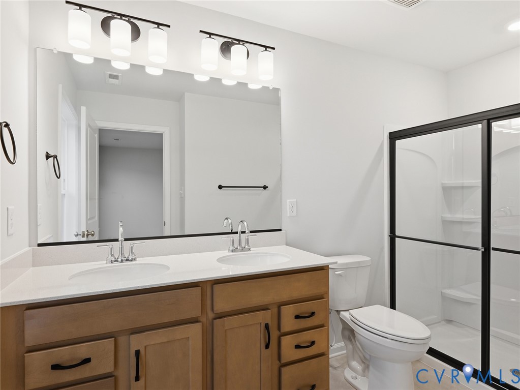 157 Corcoran Way Aylett, VA 23009 - Photo 15 of 22 a bathroom with a double vanity sink mirror and toilet