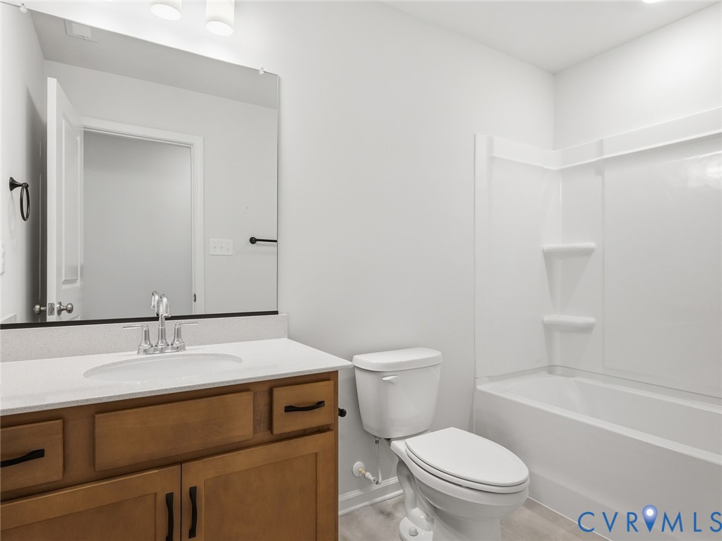 157 Corcoran Way Aylett, VA 23009 - Photo 20 of 22 a bathroom with a sink toilet vanity and shower