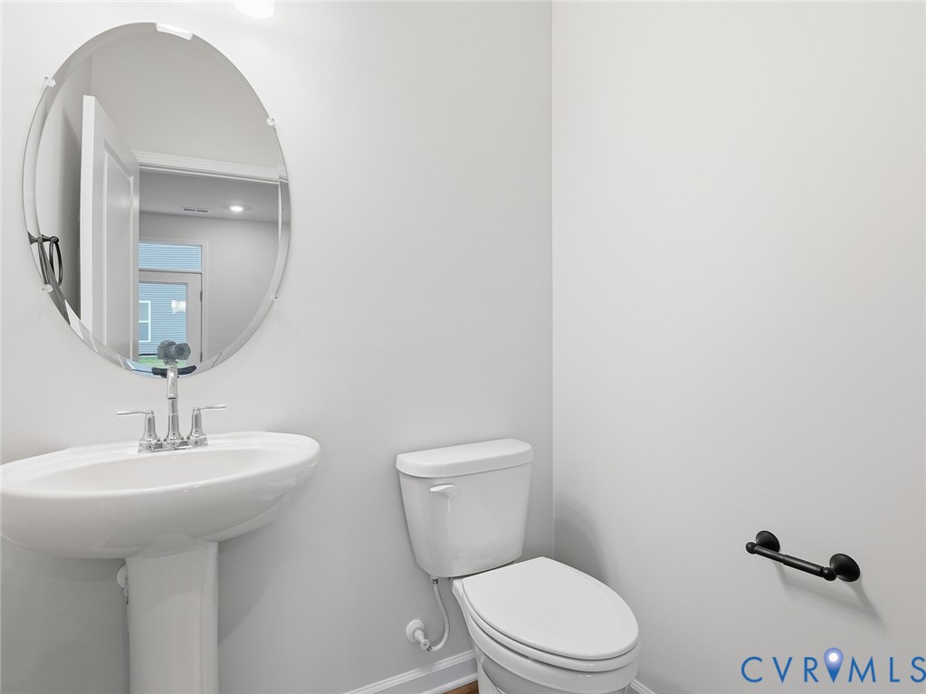 157 Corcoran Way Aylett, VA 23009 - Photo 21 of 22 a bathroom with a toilet a sink and mirror