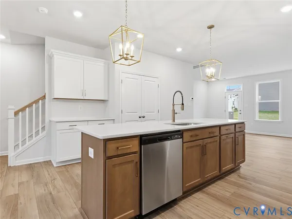 a kitchen with a sink cabinets and wooden floor
