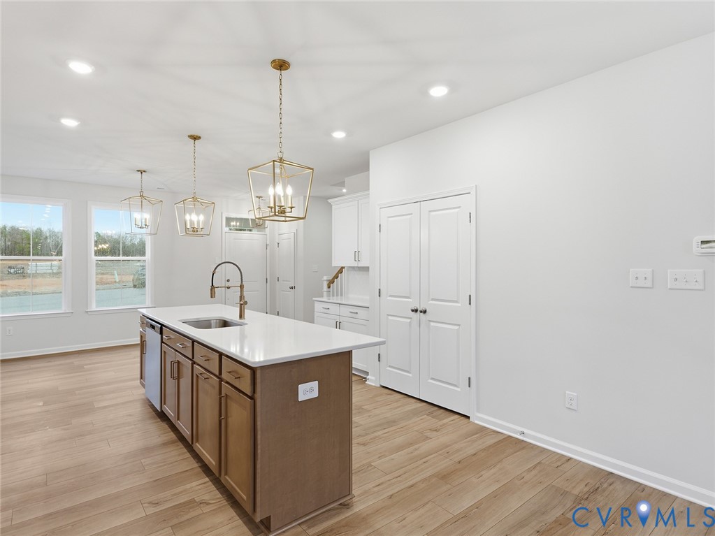 157 Corcoran Way Aylett, VA 23009 - Photo 5 of 22 a kitchen with kitchen island granite countertop a sink and a stove top oven