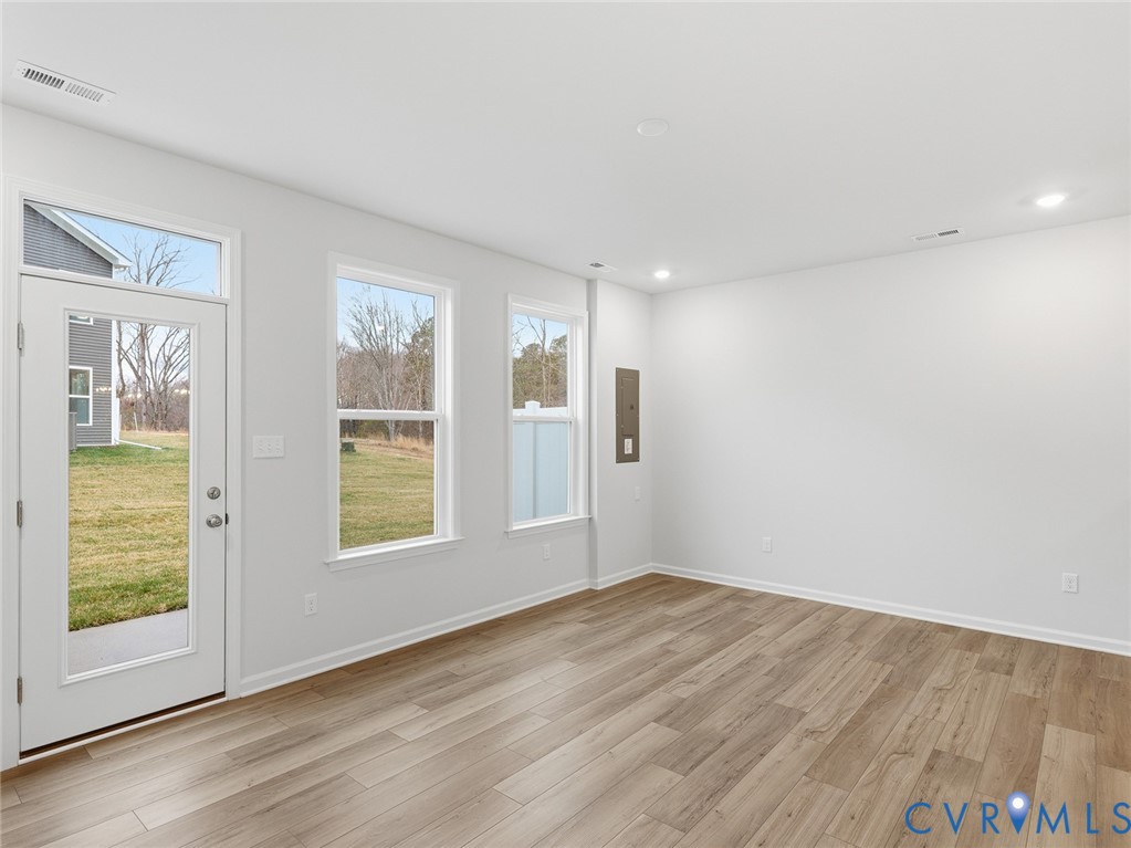 157 Corcoran Way Aylett, VA 23009 - Photo 10 of 22 an empty room with wooden floor and windows