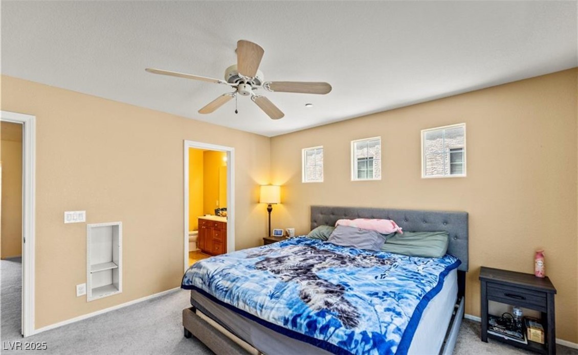 7708 Custom Weave Court Las Vegas, NV 89149 - Photo 23 of 32 Bedroom with carpet flooring, a ceiling fan, and ensuite bathroom