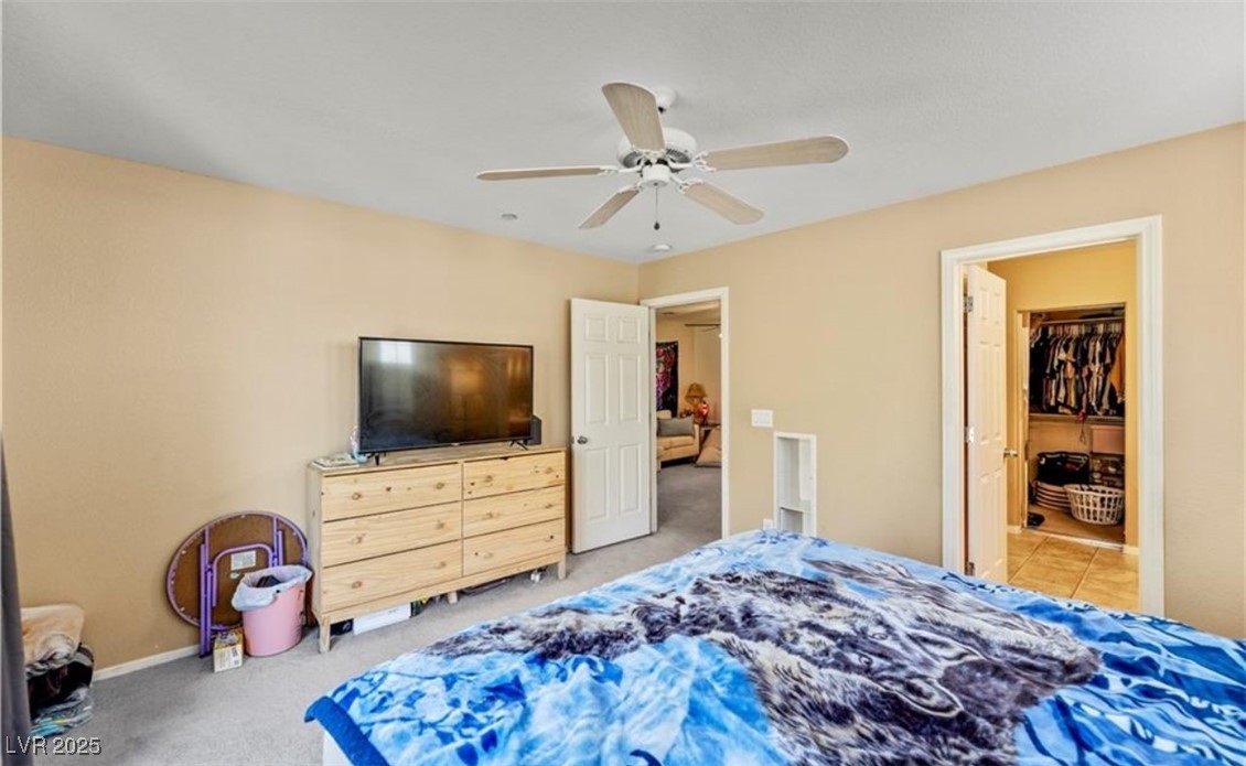 7708 Custom Weave Court Las Vegas, NV 89149 - Photo 24 of 32 Bedroom with light carpet and ceiling fan