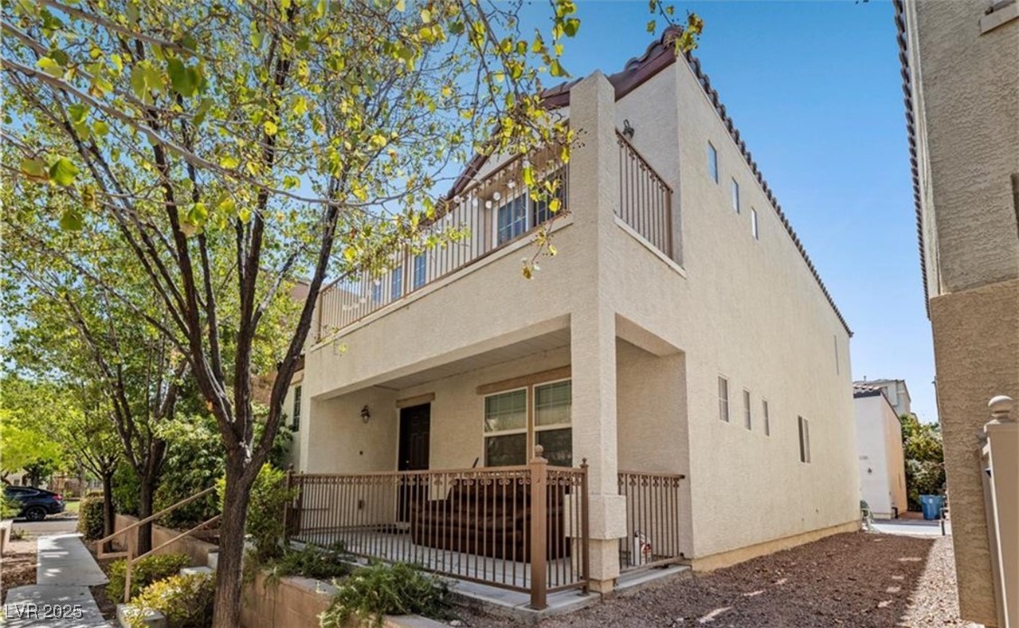 7708 Custom Weave Court Las Vegas, NV 89149 - Photo 27 of 32 View of front of home with a balcony and stucco siding