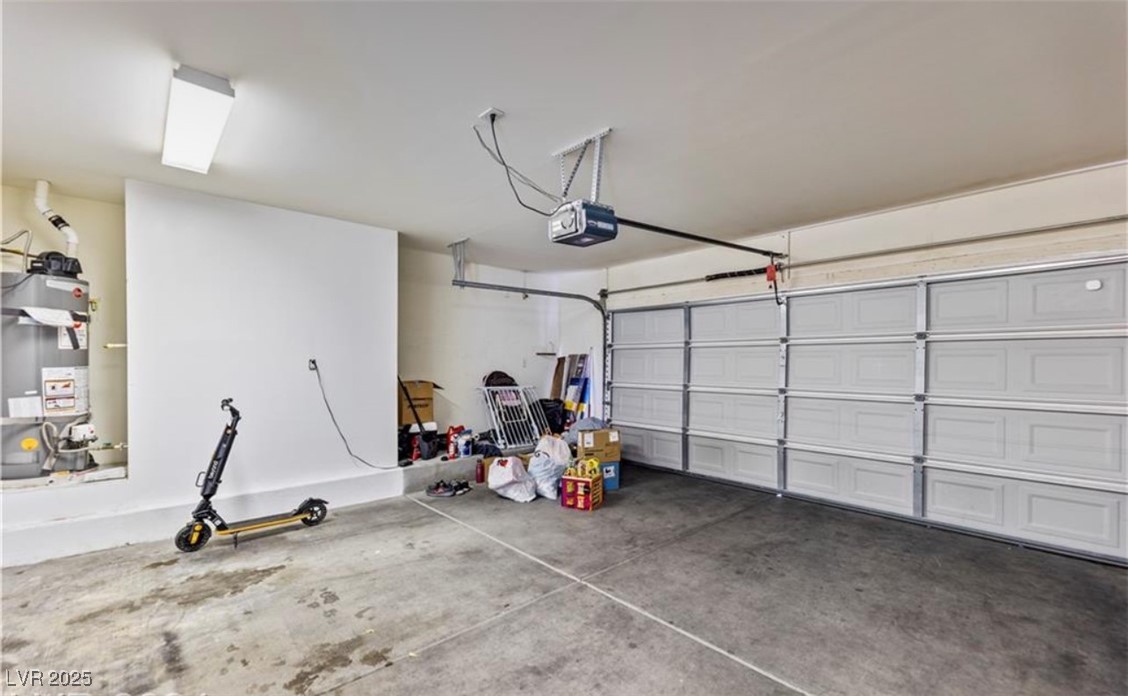 7708 Custom Weave Court Las Vegas, NV 89149 - Photo 28 of 32 Garage with water heater and a garage door opener
