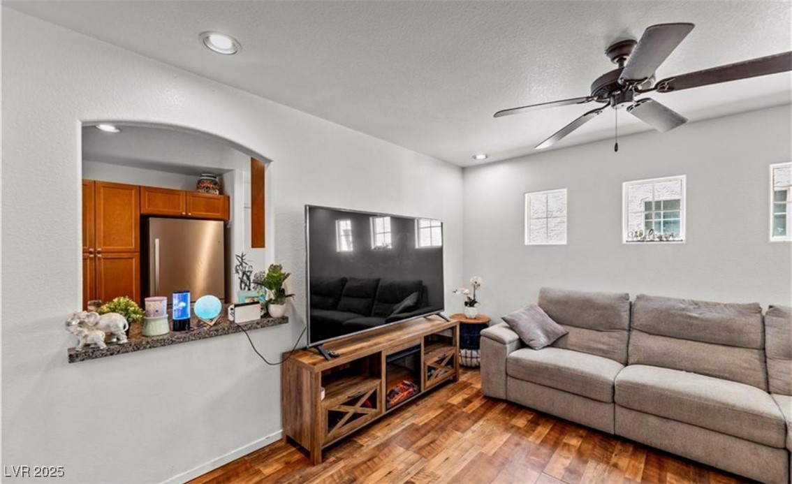 7708 Custom Weave Court Las Vegas, NV 89149 - Photo 6 of 32 Living room with light wood-style floors, ceiling fan, a textured ceiling, and recessed lighting