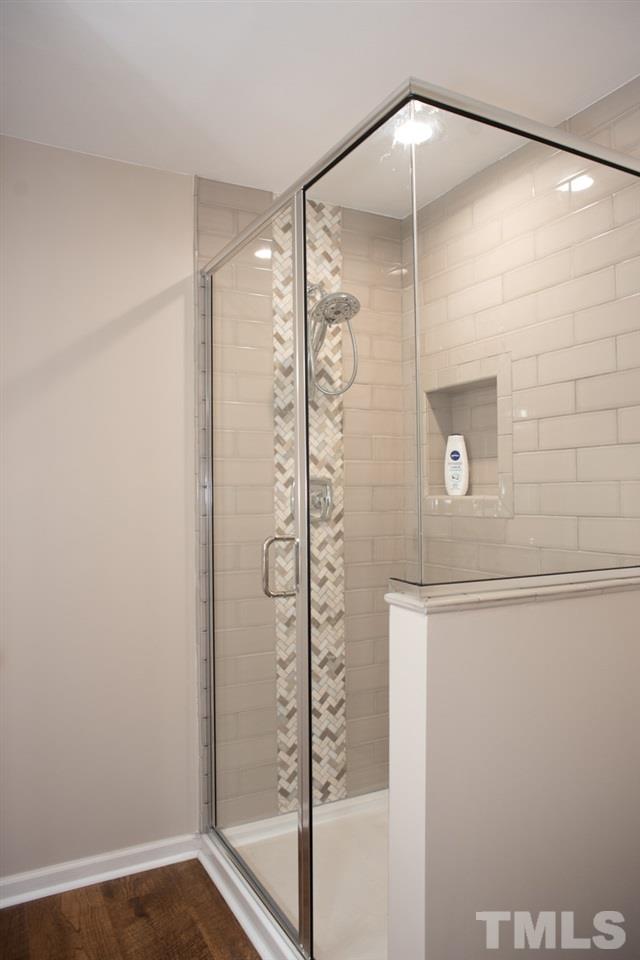 7933 Falcon Rest Circle, Unit 7933 Raleigh, NC 27615 - Photo 21 of 28 a bathroom with a shower and a glass door