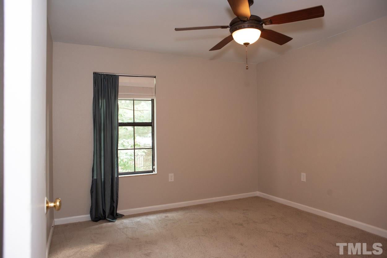 7933 Falcon Rest Circle, Unit 7933 Raleigh, NC 27615 - Photo 22 of 28 an empty room with windows and fan
