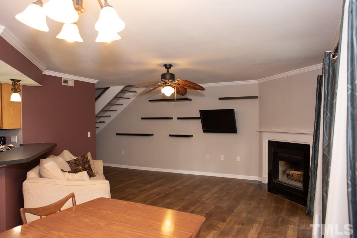 7933 Falcon Rest Circle, Unit 7933 Raleigh, NC 27615 - Photo 4 of 28 a living room with furniture and a fireplace