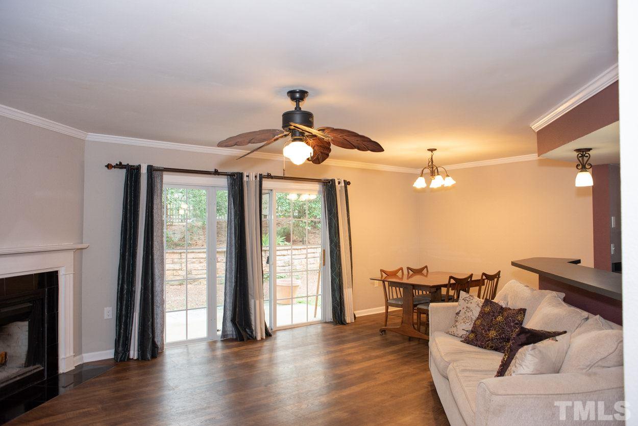 7933 Falcon Rest Circle, Unit 7933 Raleigh, NC 27615 - Photo 5 of 28 a living room with furniture and a fireplace