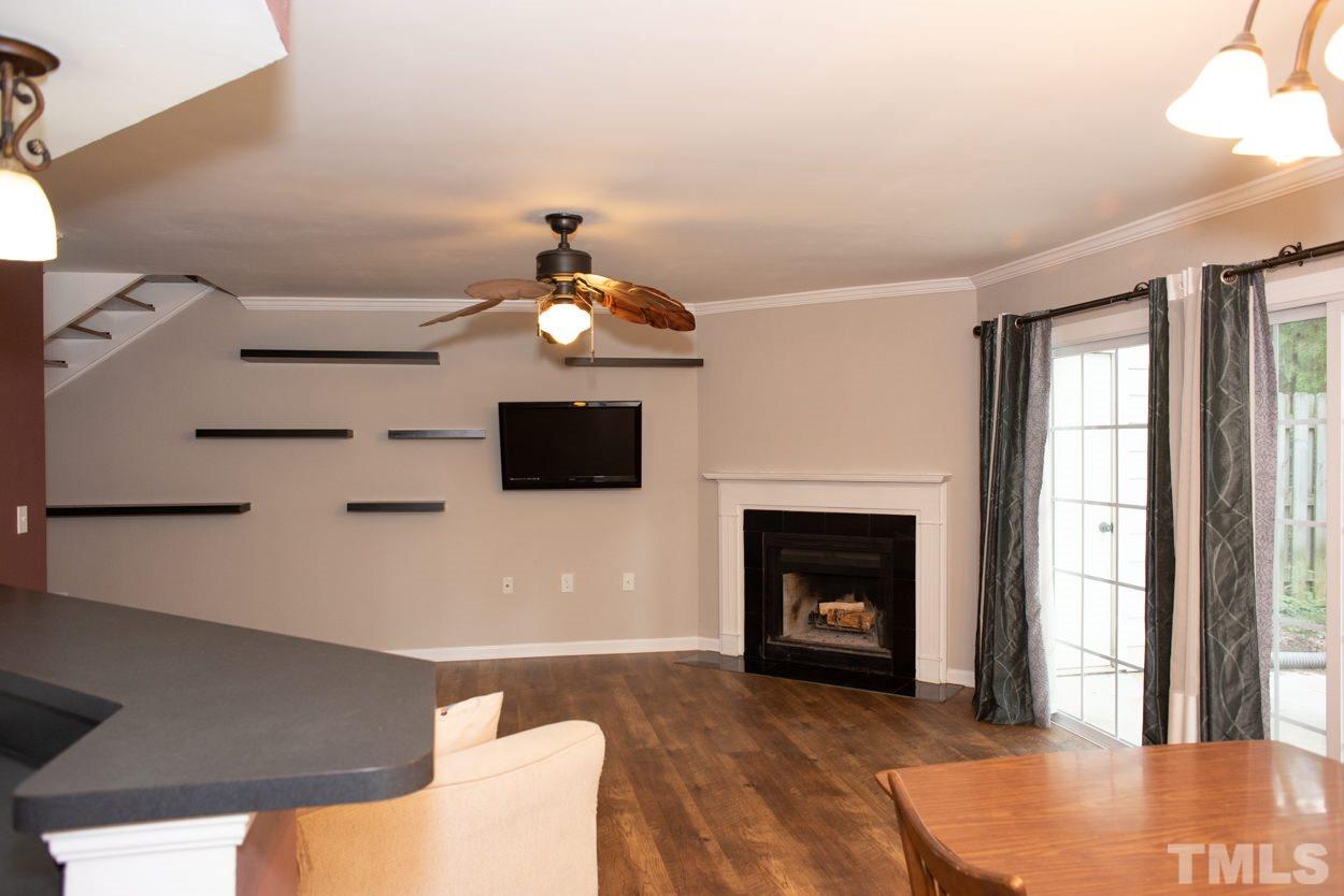 7933 Falcon Rest Circle, Unit 7933 Raleigh, NC 27615 - Photo 6 of 28 a living room with furniture and a fireplace