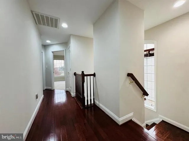 wooden floor in an empty room with a gallery