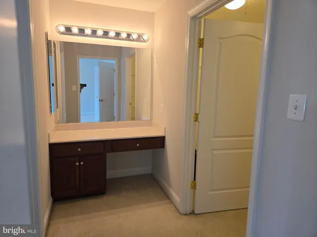 a bathroom with a sink a mirror and a window