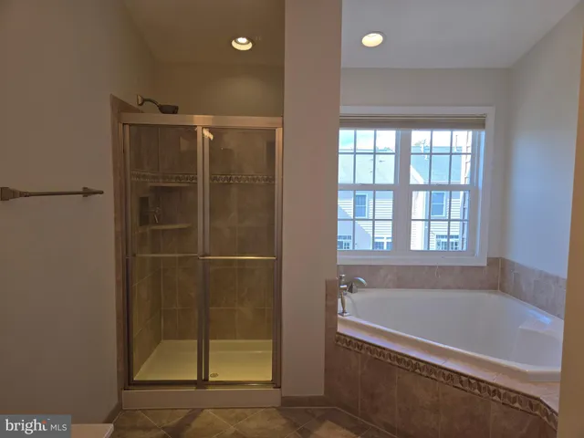 a bathroom with a tub and shower