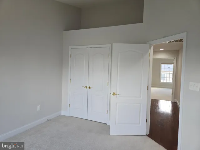 a view of an empty room and closet area