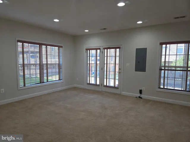 a view of an empty room with a fireplace and a window