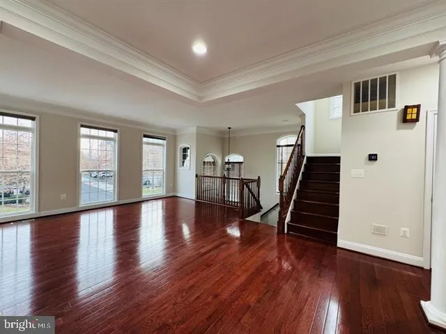 a view of an entryway with wooden floor and stairs