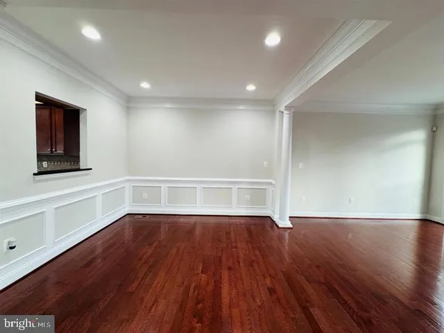 a view of a room with wooden floors and window