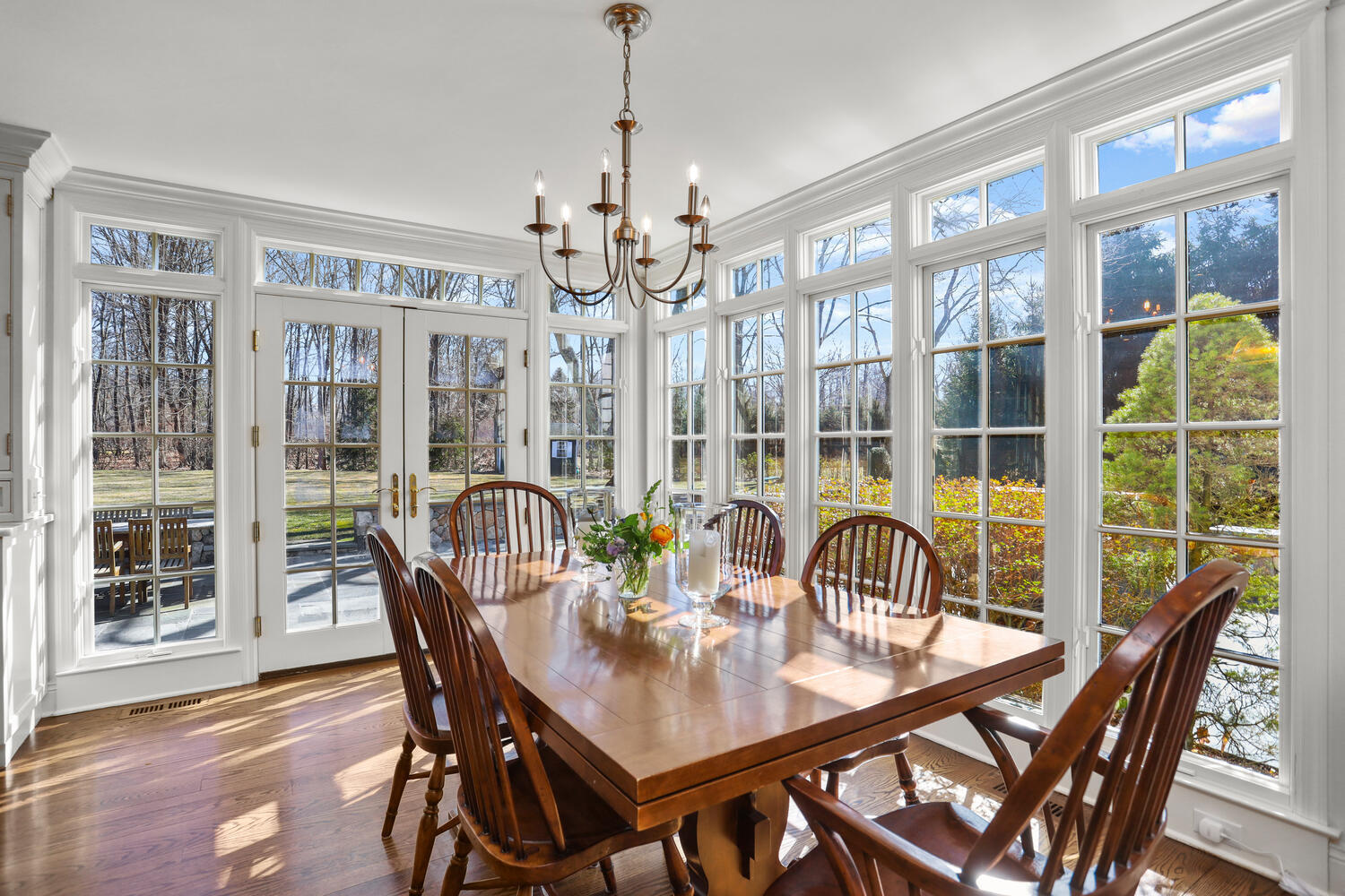 26 Beech Road New Canaan, CT 06840 - Photo 11 of 41 a dining room with furniture a chandelier and wooden floor