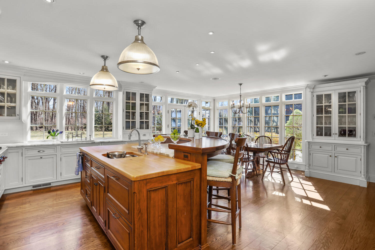 26 Beech Road New Canaan, CT 06840 - Photo 12 of 41 a open kitchen with stainless steel appliances granite countertop a stove and a dining table with wooden floor