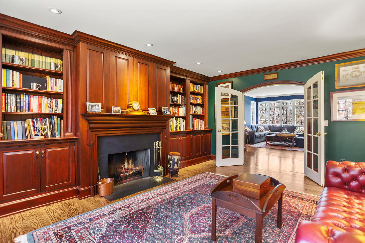 26 Beech Road New Canaan, CT 06840 - Photo 17 of 41 a living room with furniture a fireplace and a book shelf