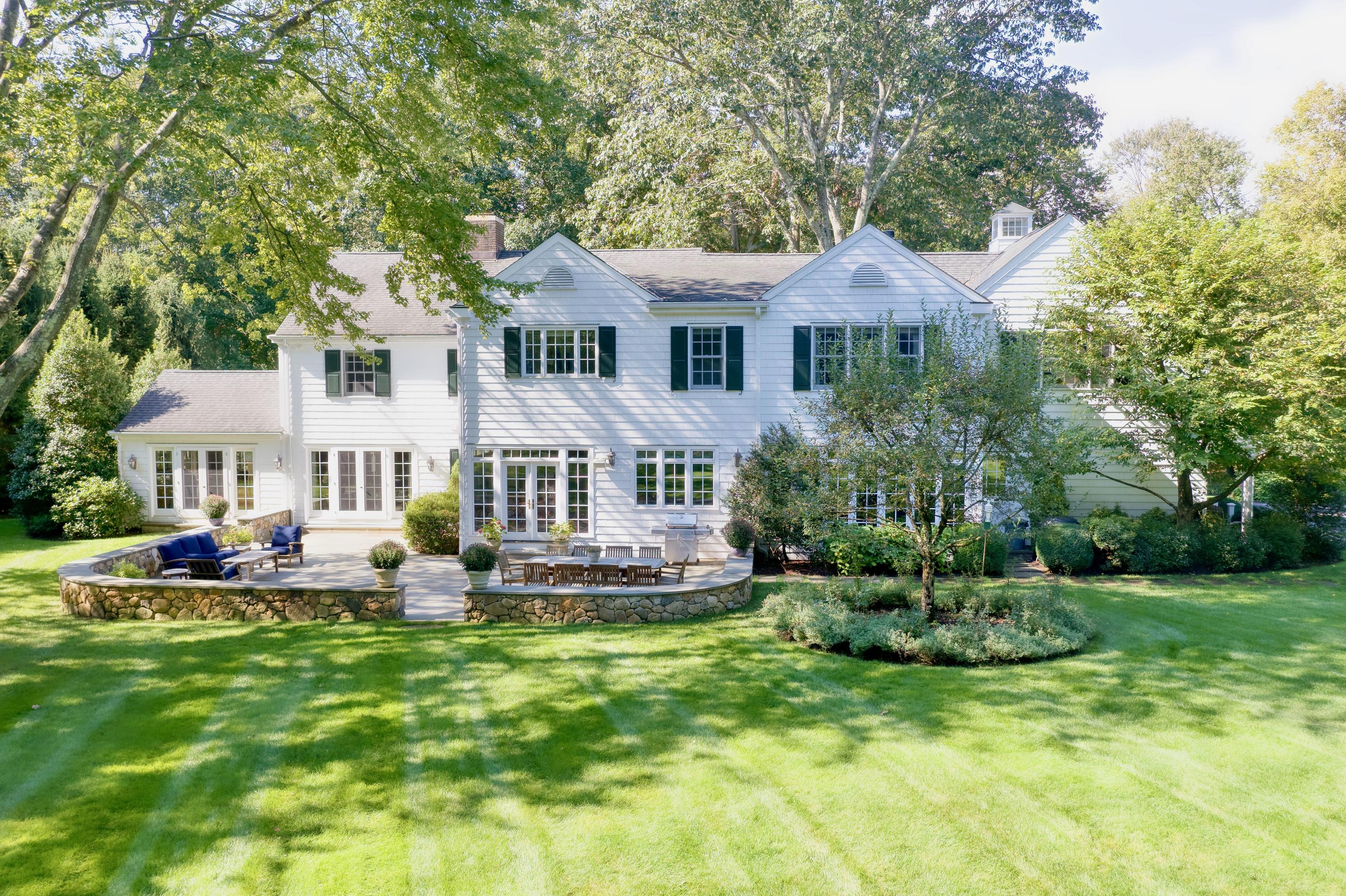 26 Beech Road New Canaan, CT 06840 - Photo 3 of 41 a front view of a house with a garden