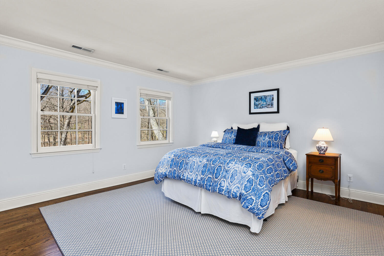 26 Beech Road New Canaan, CT 06840 - Photo 30 of 41 a bedroom with a bed and a lamp on table