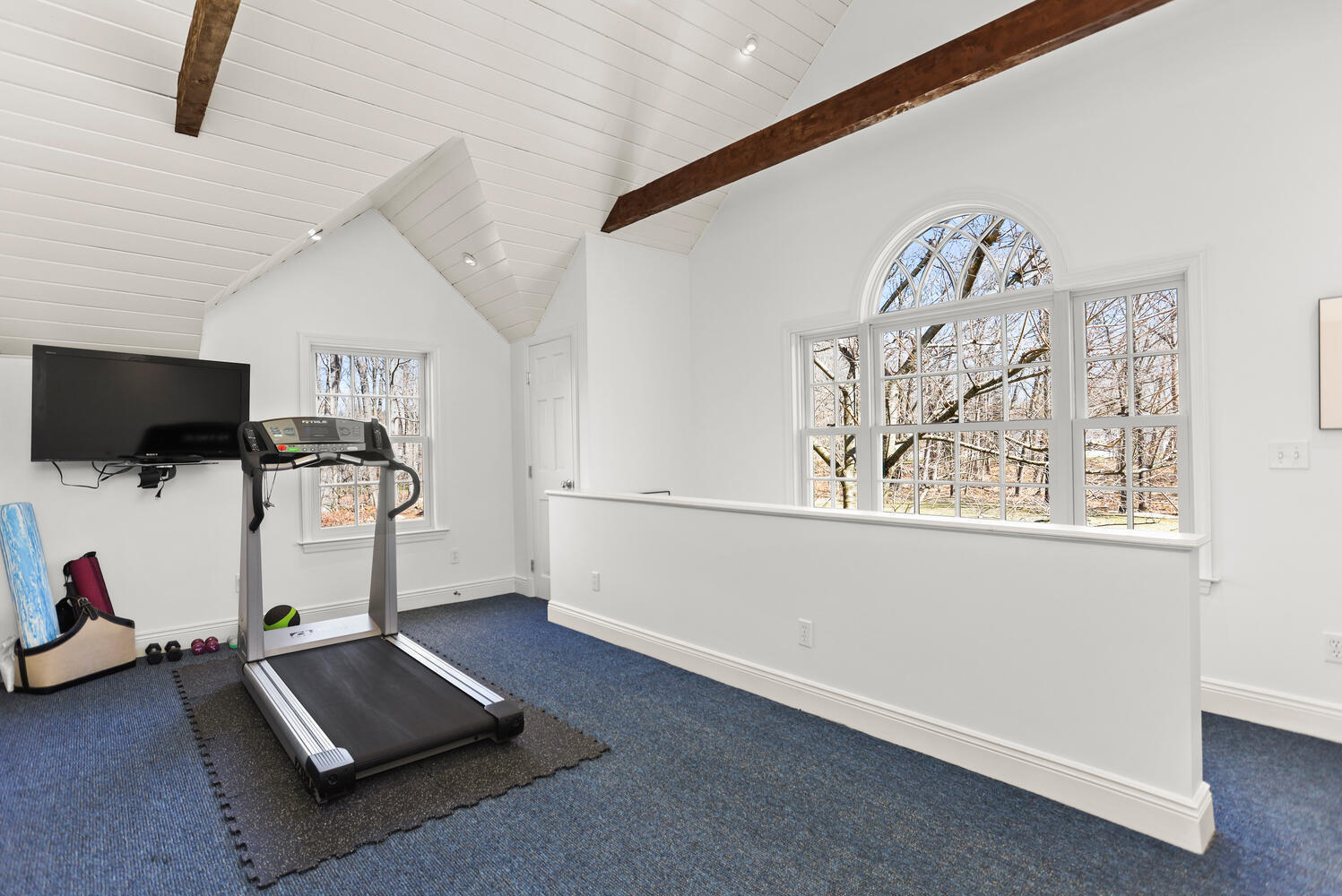 26 Beech Road New Canaan, CT 06840 - Photo 37 of 41 a room with gym equipment and a flat screen tv