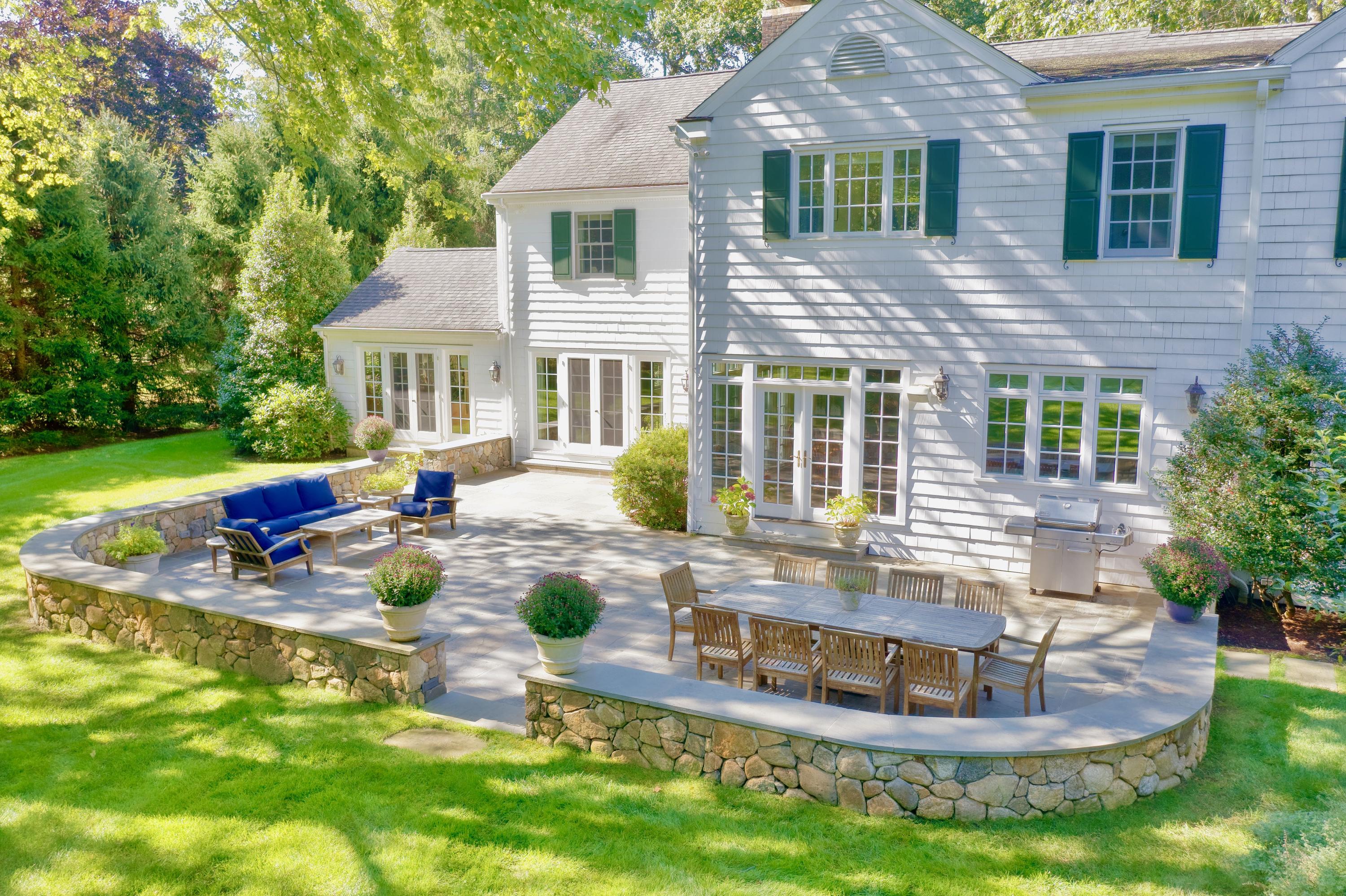 26 Beech Road New Canaan, CT 06840 - Photo 7 of 41 a front view of a house with garden and trees