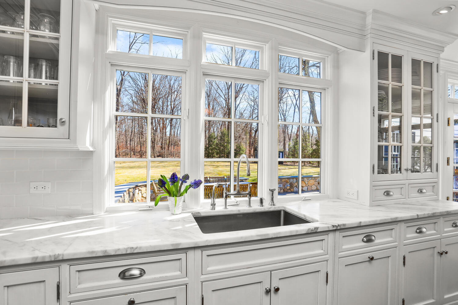 26 Beech Road New Canaan, CT 06840 - Photo 10 of 41 a kitchen with granite countertop a sink and a large window