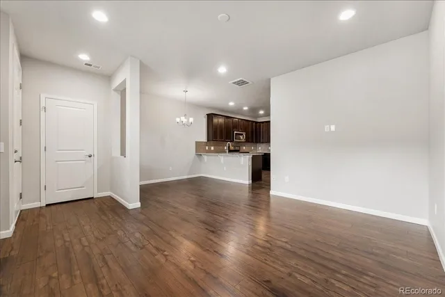 a view of kitchen with refrigerator microwave and wooden floor