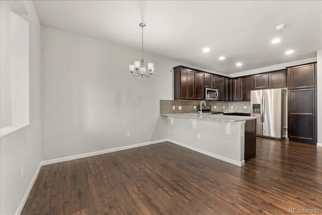 a kitchen with stainless steel appliances wooden cabinets and a stove top oven
