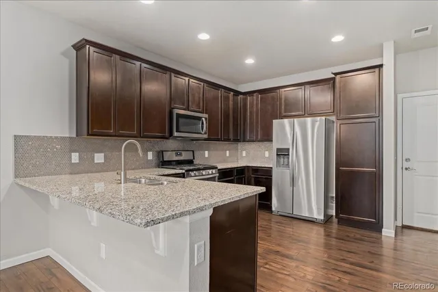 a stove top oven sitting inside of a kitchen
