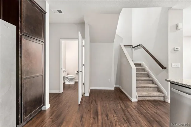 a bathroom with a granite countertop bathtub a double vanity sink and a mirror