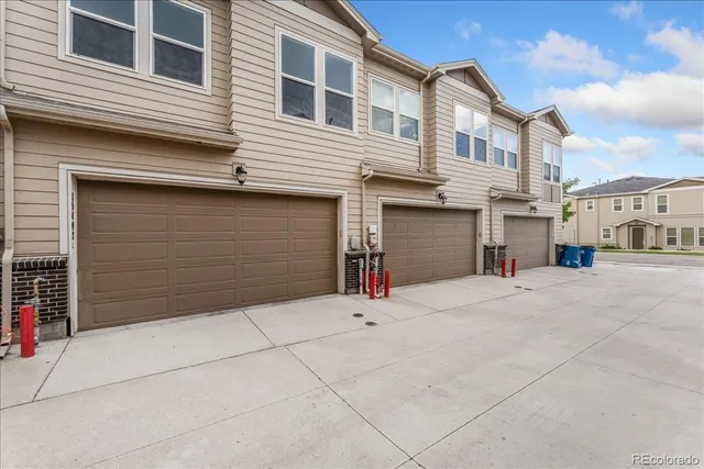 an aerial view of a house with garden space and patio