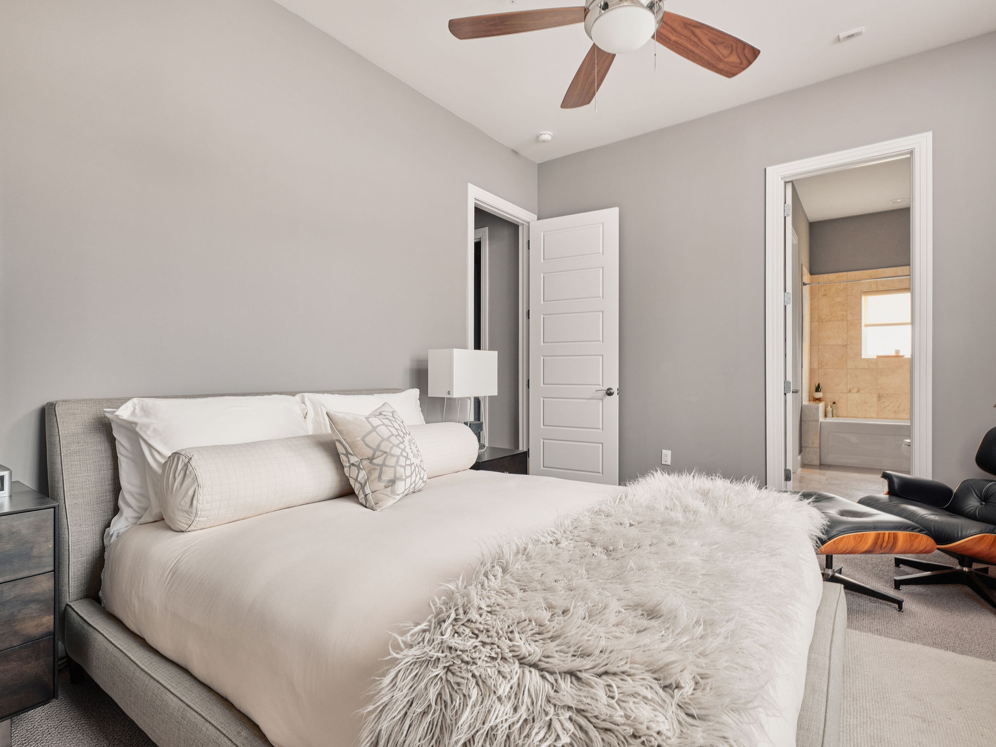 1504 Collier Street, Unit 4 Austin, TX 78704 - Photo 29 of 38 Carpeted bedroom featuring a ceiling fan and ensuite bath