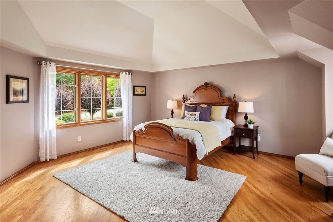 21127 47th Drive Southeast Bothell, WA 98021 - Photo 17 of 38 a bedroom with a bed and wooden floor