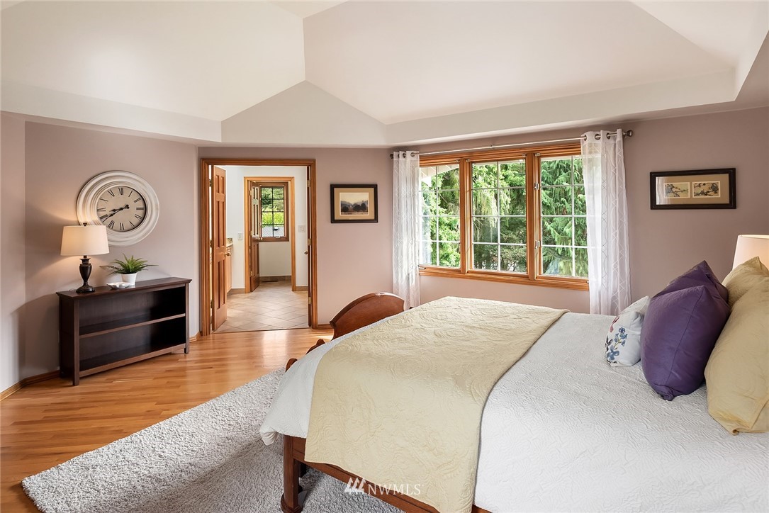 21127 47th Drive Southeast Bothell, WA 98021 - Photo 18 of 38 a bedroom with a bed and a dresser next to a window