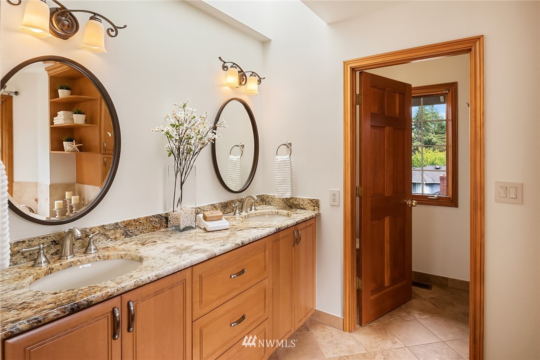 21127 47th Drive Southeast Bothell, WA 98021 - Photo 19 of 38 a bathroom with a granite countertop sink and a mirror
