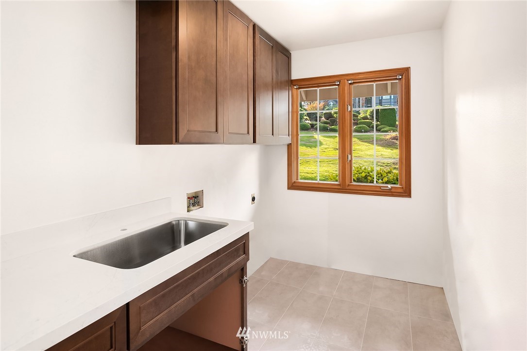 21127 47th Drive Southeast Bothell, WA 98021 - Photo 27 of 38 a kitchen with a sink and cabinets
