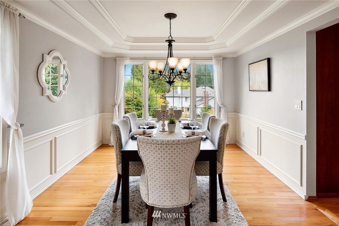 21127 47th Drive Southeast Bothell, WA 98021 - Photo 8 of 38 a dining room with furniture a chandelier and wooden floor