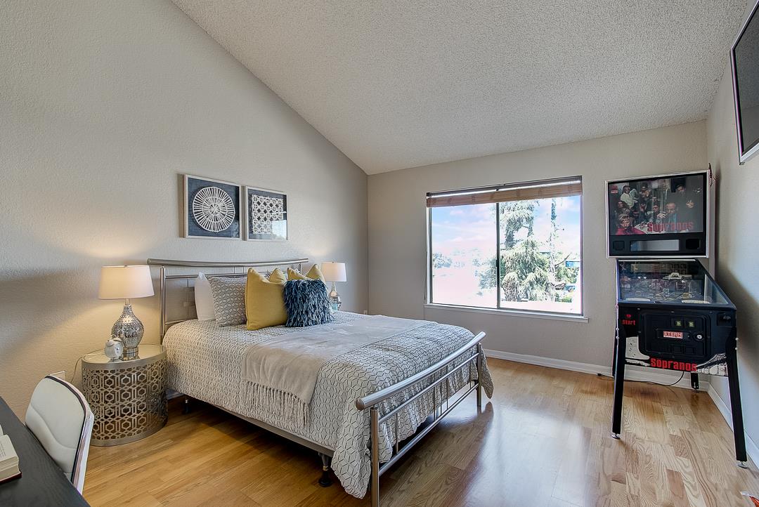 1303 Victoria Terrace Sunnyvale, CA 94087 - Photo 17 of 27 a bedroom with a bed window and a table
