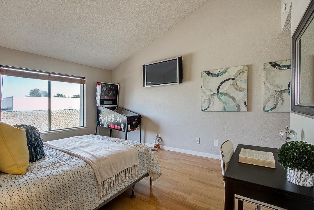 1303 Victoria Terrace Sunnyvale, CA 94087 - Photo 18 of 27 a bedroom with a bed a computer on the desk and chair with wooden floor