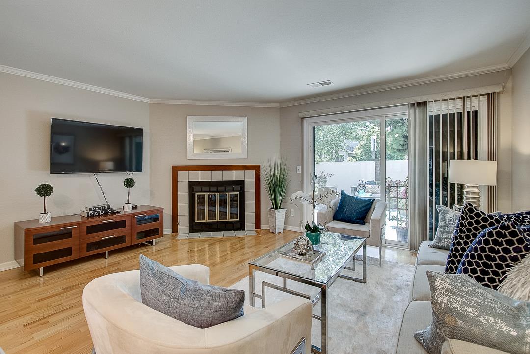 1303 Victoria Terrace Sunnyvale, CA 94087 - Photo 3 of 27 a living room with furniture a flat screen tv and a fireplace