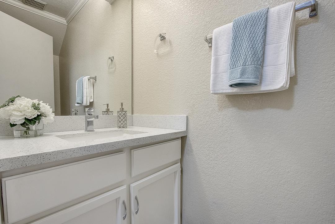1303 Victoria Terrace Sunnyvale, CA 94087 - Photo 9 of 27 a bathroom with a sink vanity and mirror
