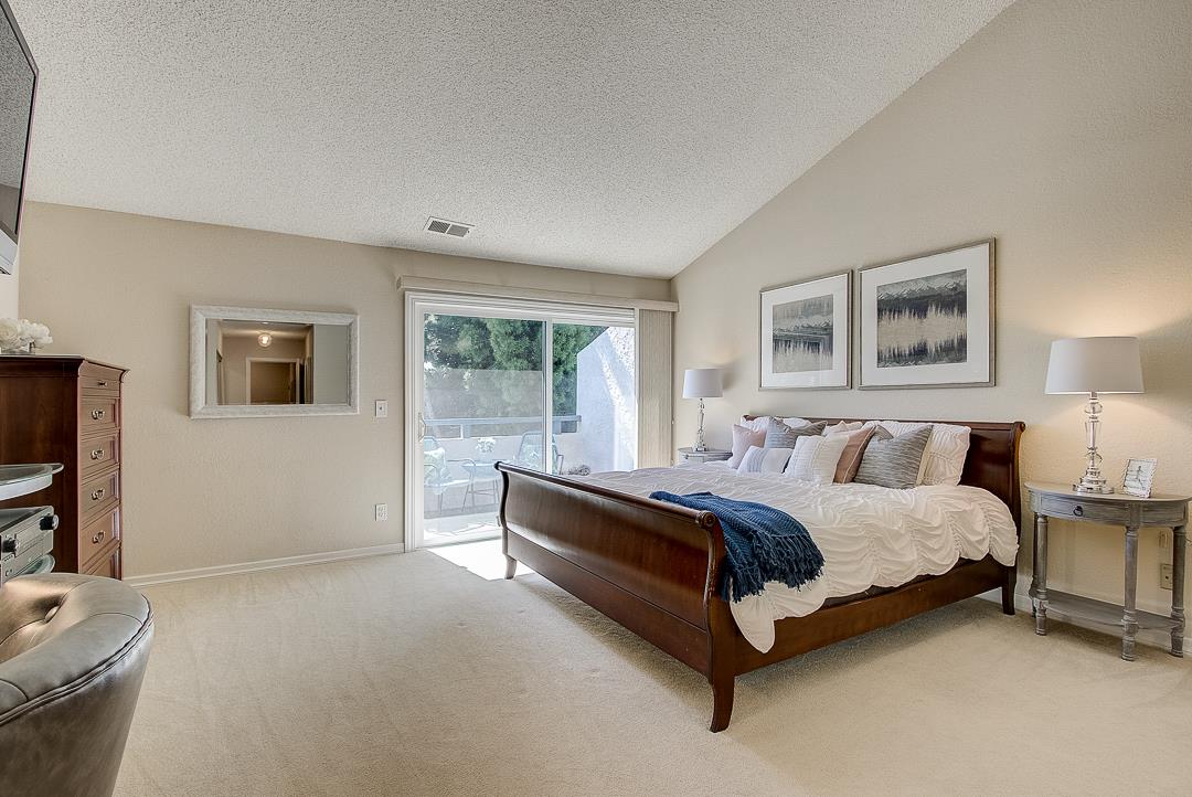 1303 Victoria Terrace Sunnyvale, CA 94087 - Photo 10 of 27 a spacious bedroom with a bed and a flat screen tv